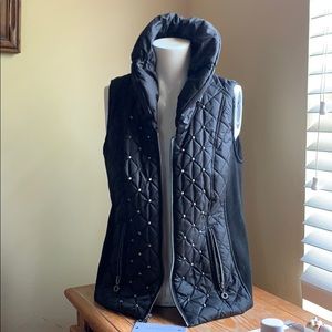 Puffy vest with silver stud detail and high collar